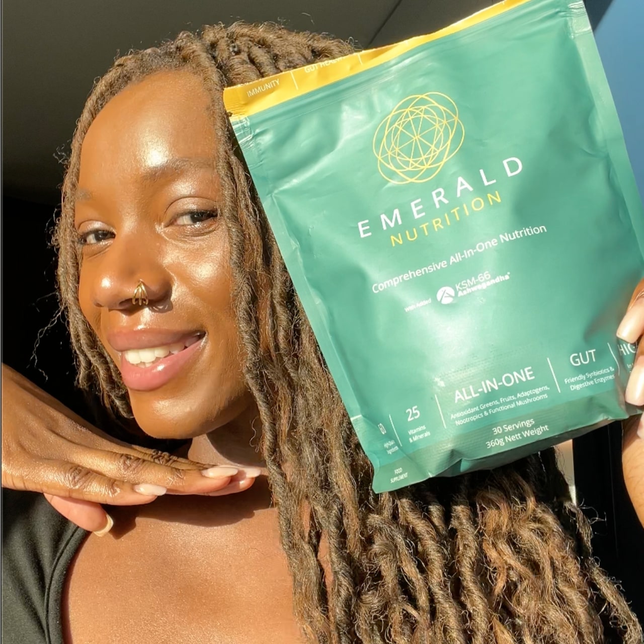 Person holding a Emerald Nutrition package with a blurred background