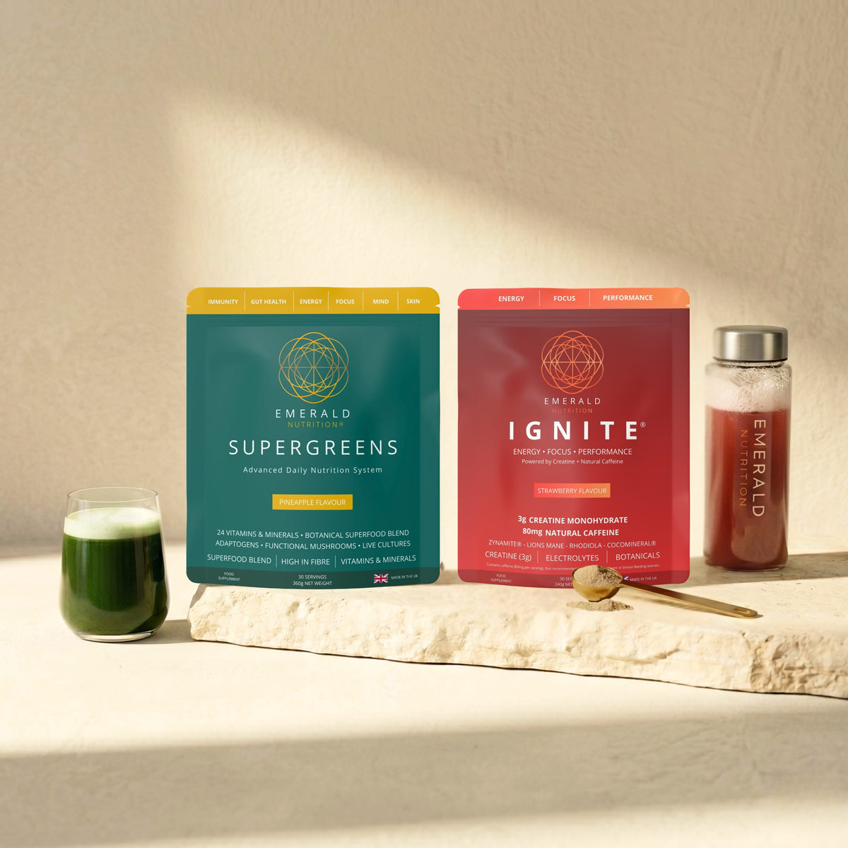 Emerald Nutrition Supergreens tub with gold scoop and water bottle