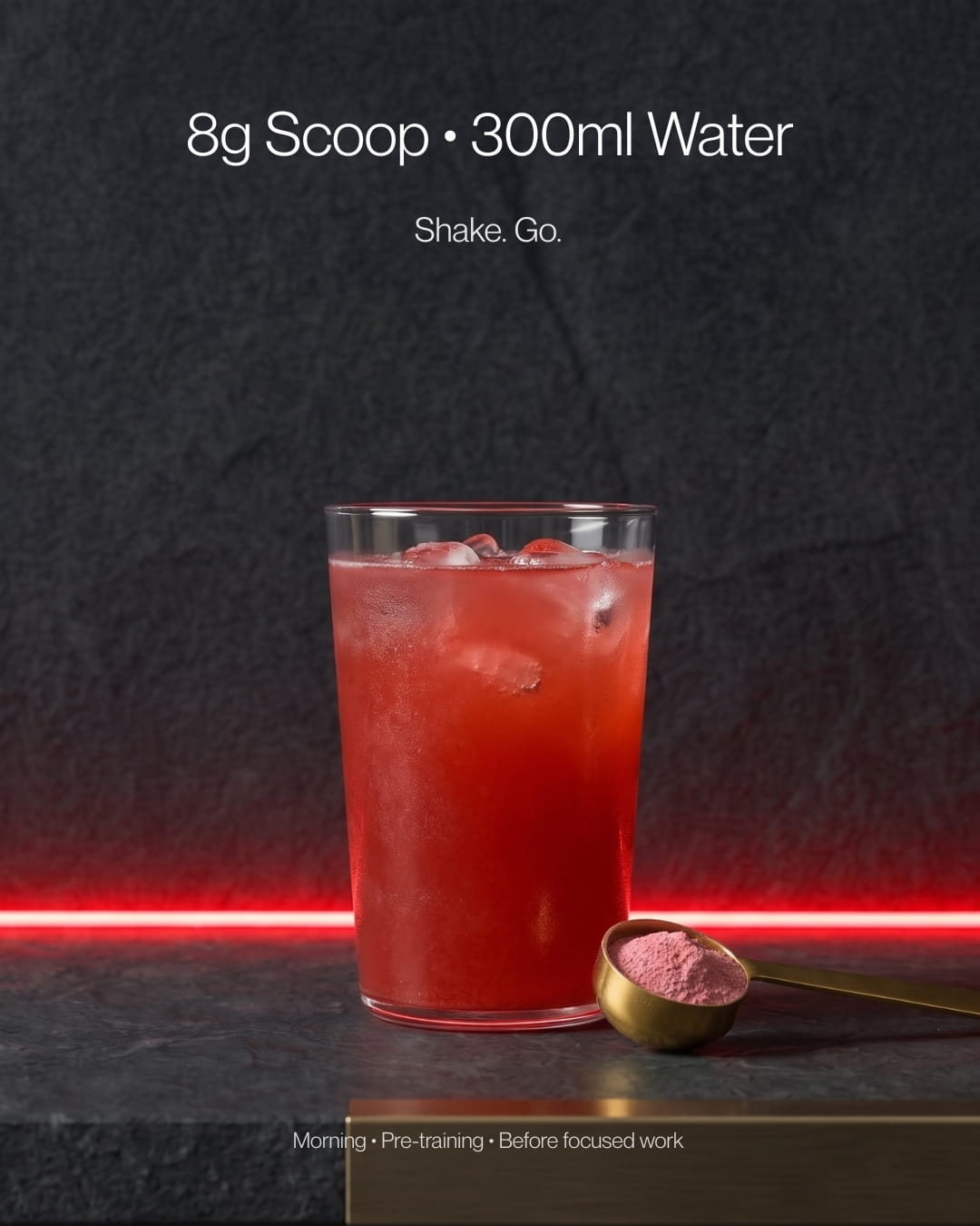 Glass of red coloured drink next to a scoop of pink coloured powder