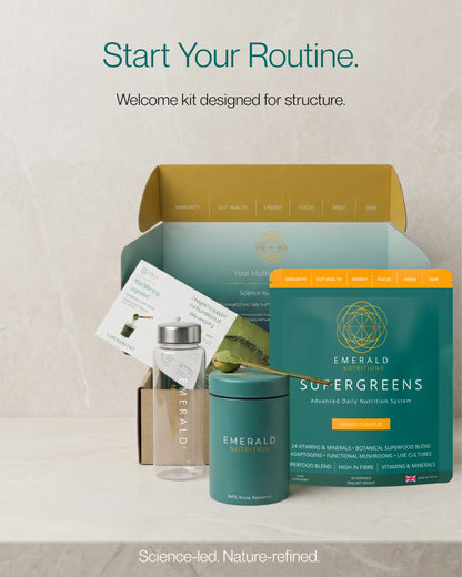 Emerald Supergreens supplement kit with a bottle and packaging on a light background