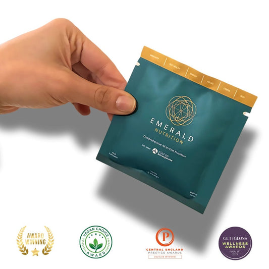 Hand holding a Emerald Nutrition package with certification logos at the bottom.